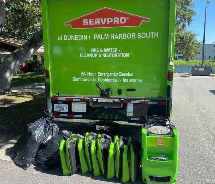 SERVPRO equipment in front of green service vehicle